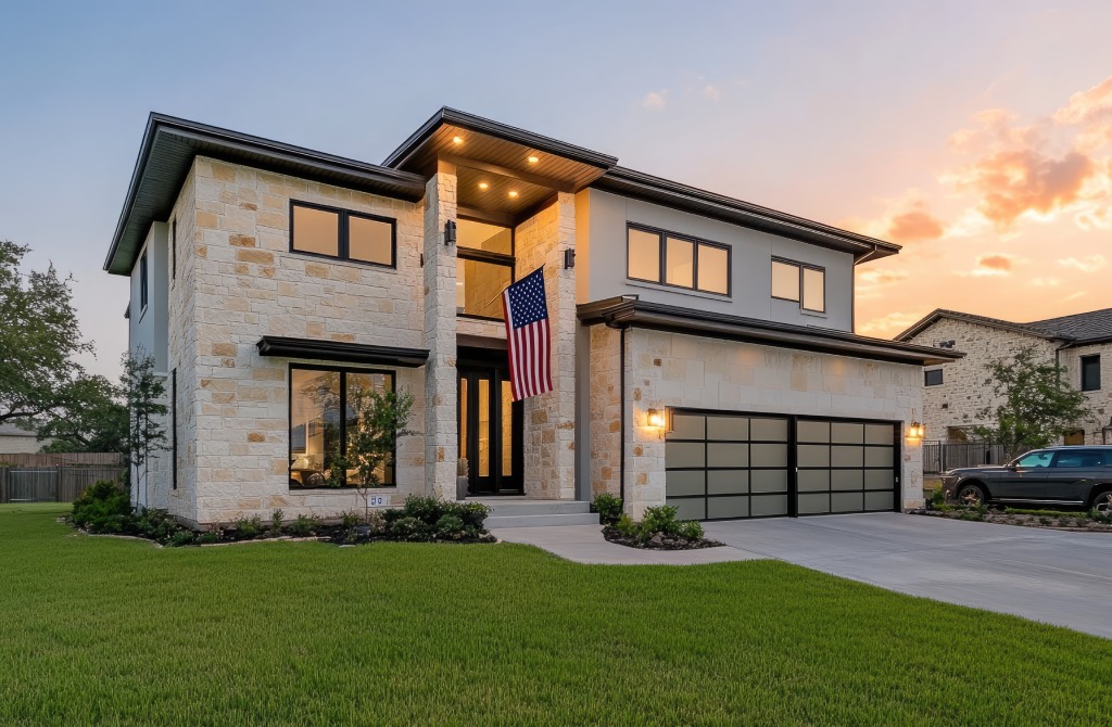Contemporary Two Story Stone Home with Black Trim Windows and American Flag at Sunset.jpg