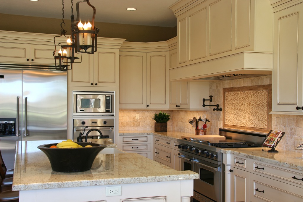 Luxury French Country Kitchen with Cream Glazed Cabinets Granite Island and Wrought Iron Chandelier.jpg