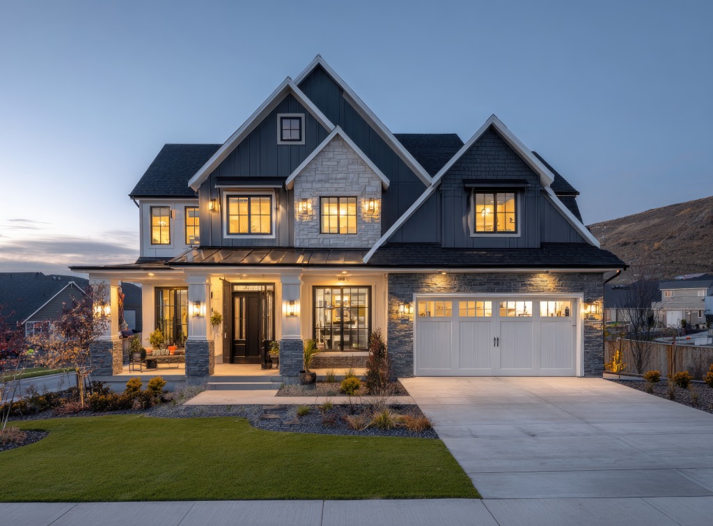 Luxury Modern Craftsman at Twilight with Navy Siding Stone Accents and Illuminated Entry.jpg
