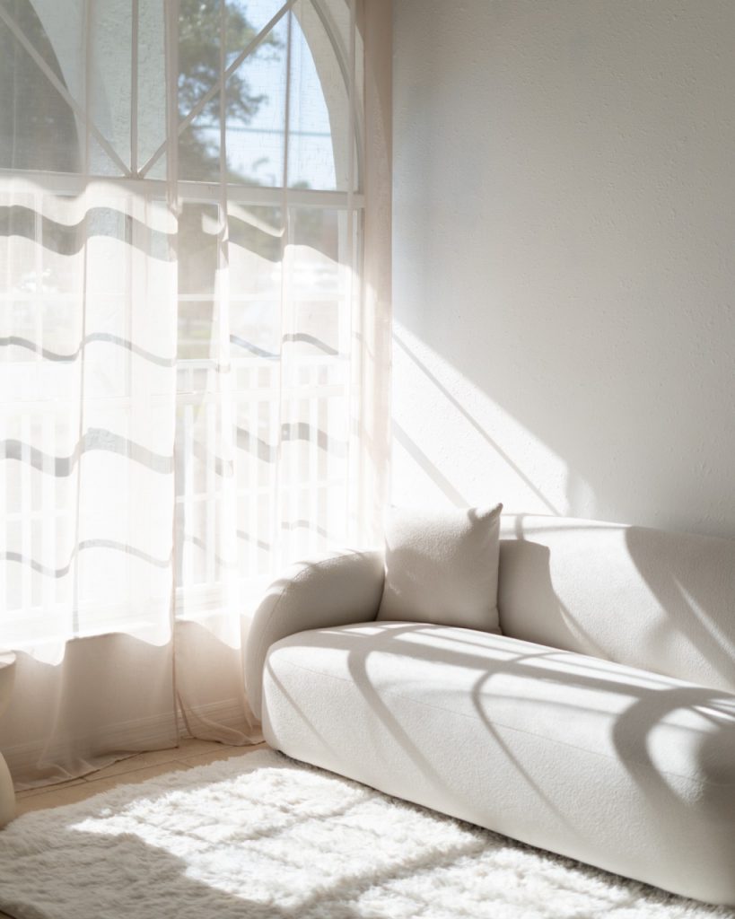 Minimalist Cream Living Room with Boucle Sofa Sheer Curtains and Natural Sunlight Shadows.jpg