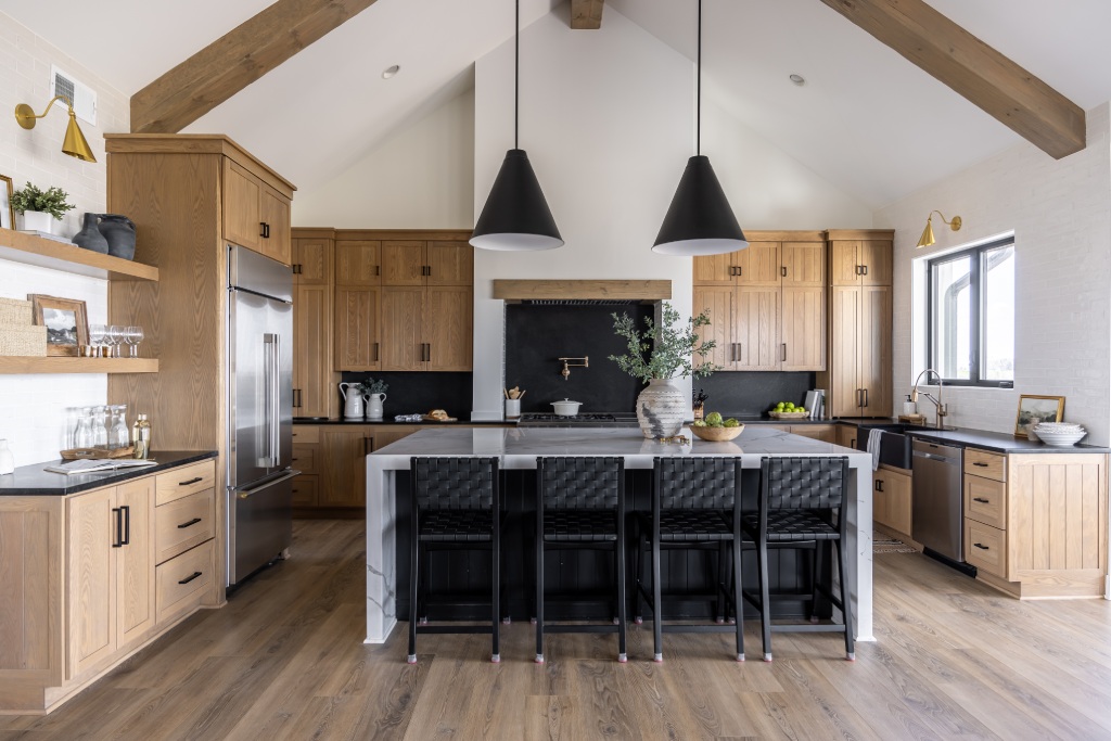 Modern Farmhouse Kitchen with Cathedral Ceiling Exposed Oak Beams Marble Water Waterfall Island and Black Pendants.jpg