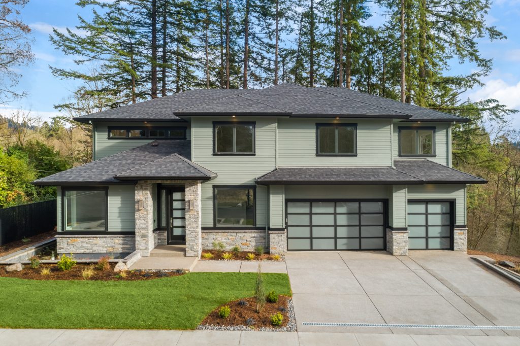 Modern Sage Green Home with Stone Veneer Black Trim and Frosted Glass Garage Doors.jpg