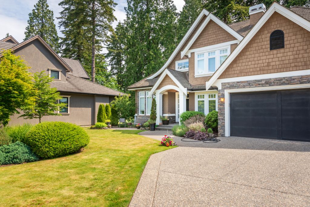 Pacific Northwest Craftsman Home with Brown Shake Siding Stone Accents and Exposed Aggregate Driveway.jpg